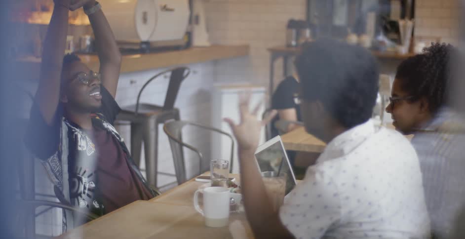A group of people sit around a table talking