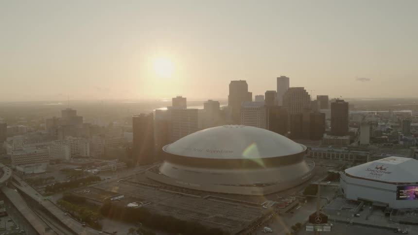 Sunlight shines over skyscrapers and domed buildings in a city