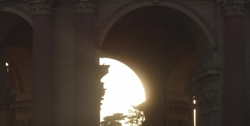 Bright sun shining through a stone archway