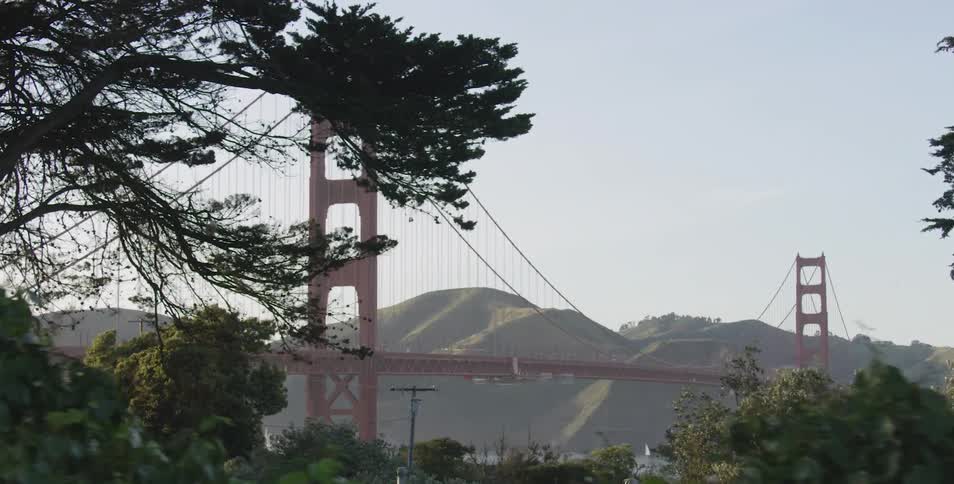 Driving past the golden gate bridge with mountains in the background