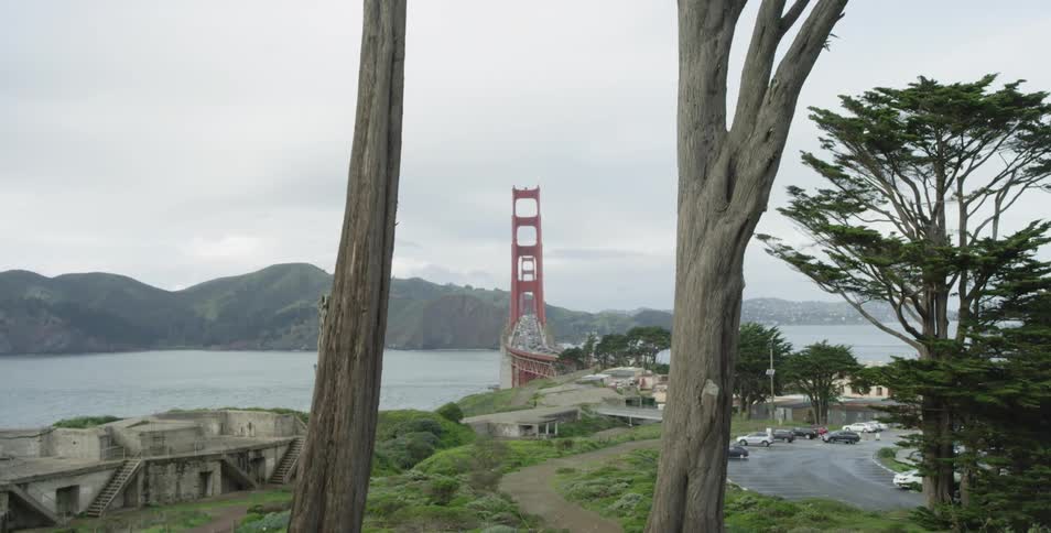 Golden gate bridge with range of mountains on a cloudy day