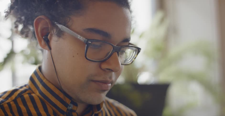 A person putting earbuds in their ear