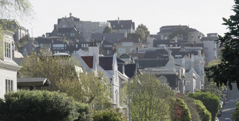 Hilly city street with houses