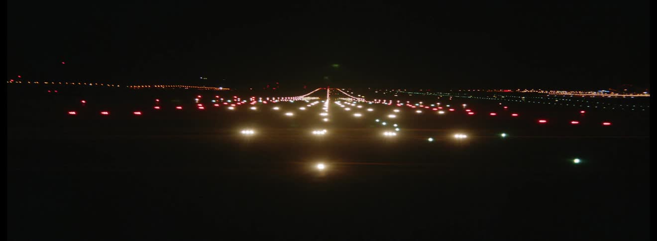 Bright lights on the runway shine and shimmer at night