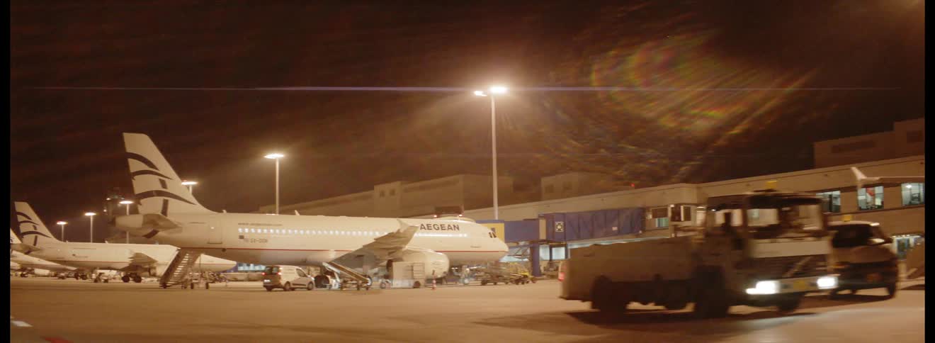 An airport at night at a terminal for commercial aircraft