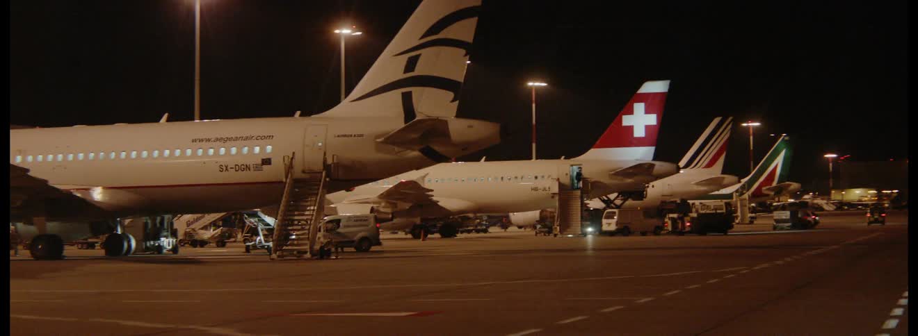 Airplanes lined up at gates at an airport
