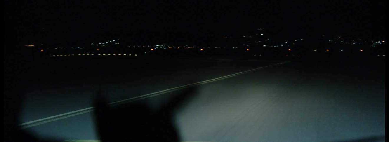 Vehicle driving down an airport tarmac