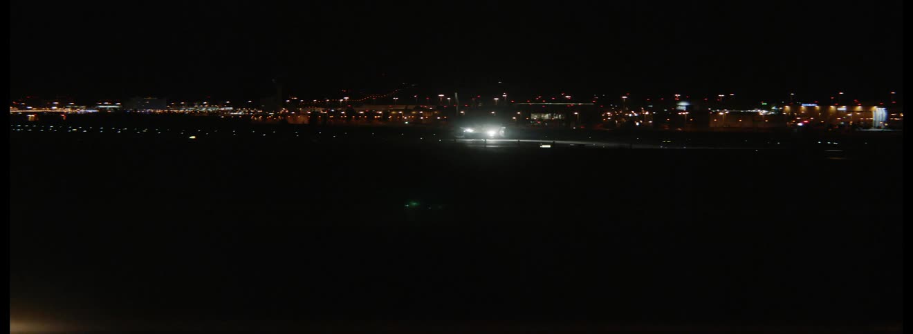 An aircraft on a runway at night