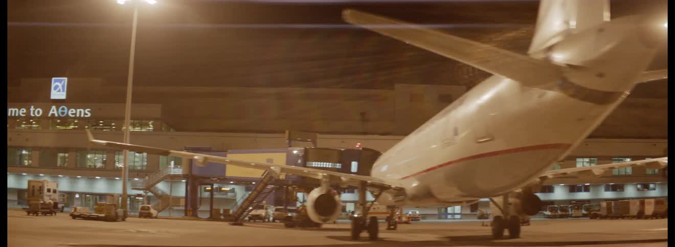 Athens airport viewed at night as a commercial aircraft readies for a flight