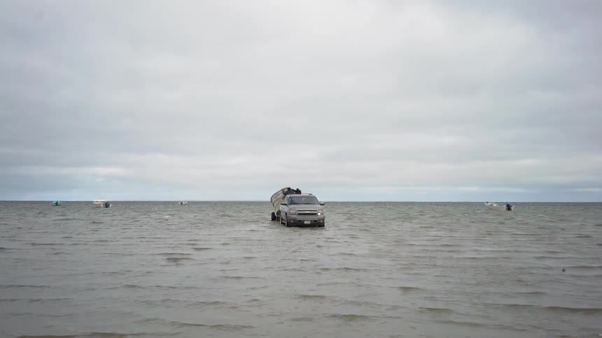 Car sitting in shallow body of water