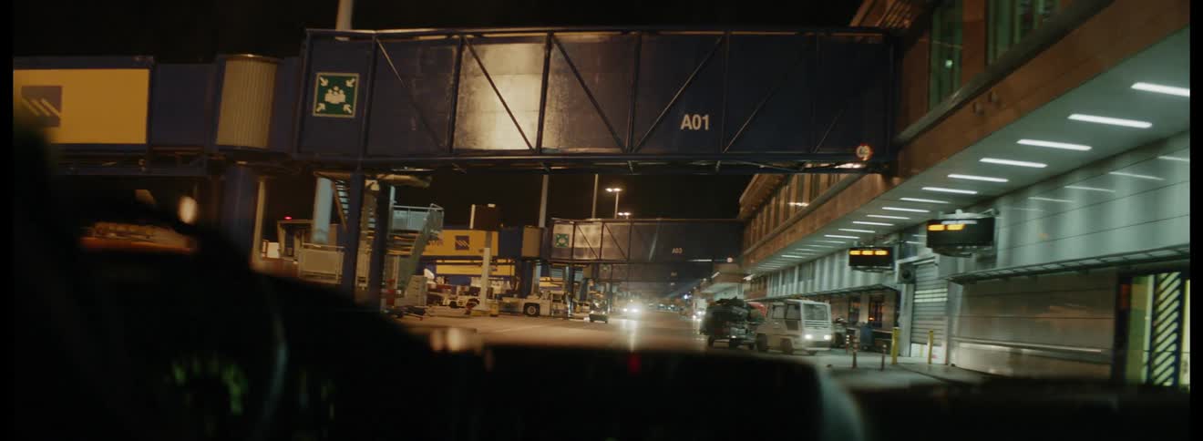 A person driving a vehicle down a city street near an airport