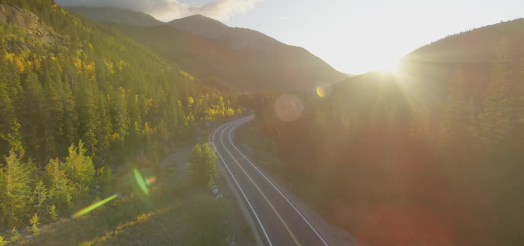 Aerial view of road winding through mountains