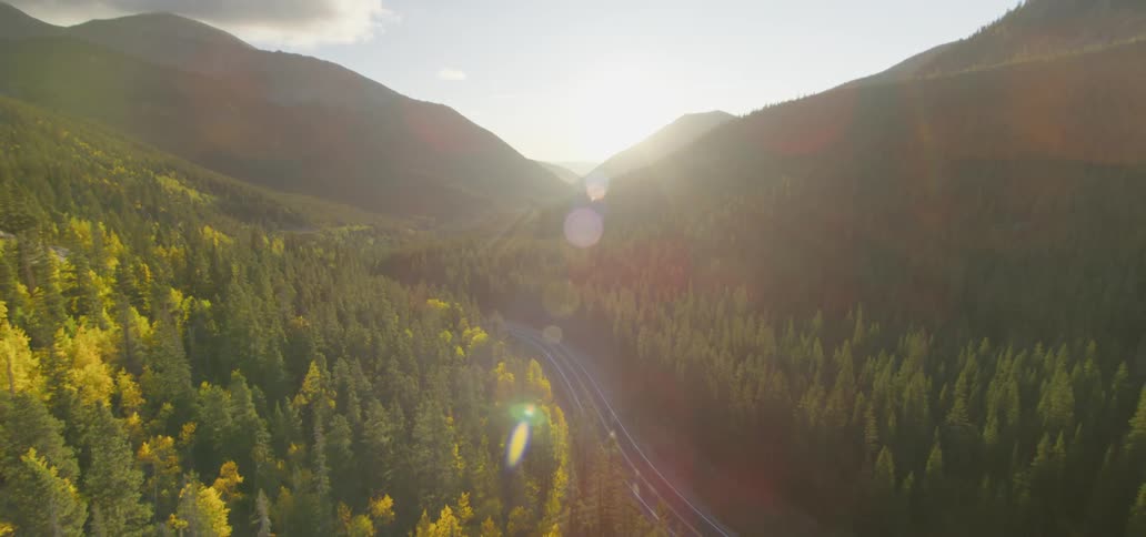 A highway surrounded by woods and mountains