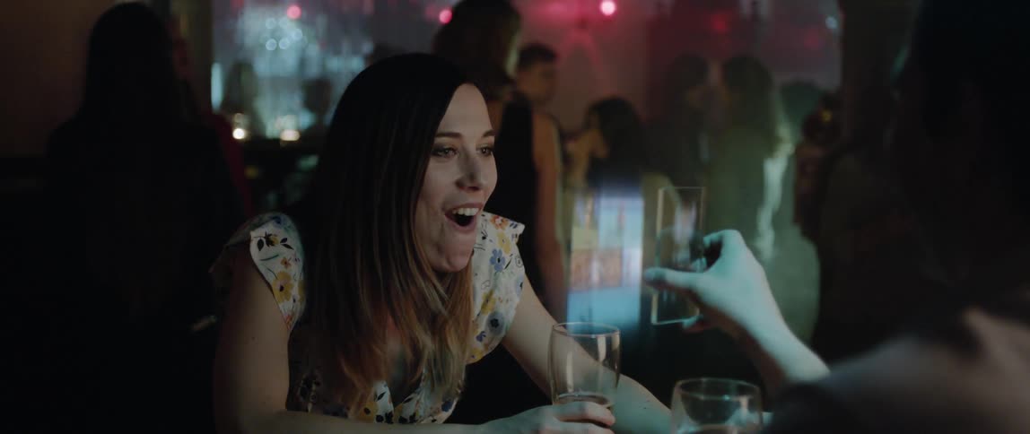 A person is showing a phone to a girl