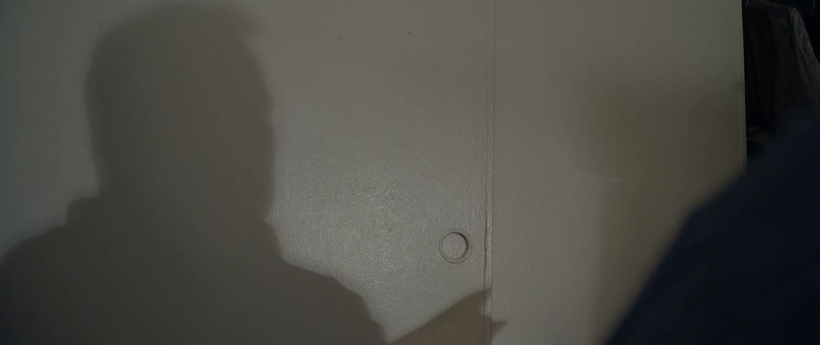 A shadow of a male sneezing and holding a paper