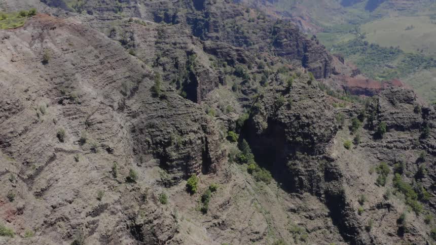 Aerial photography of a rocky mountains and grass covered canyons
