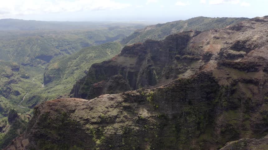 Range of steep mountains with clouds on a sunny day