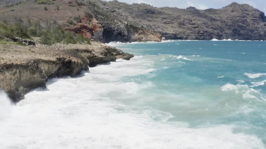 A body of water with waves crashing into the land