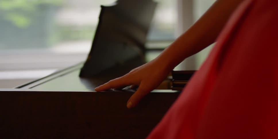 Woman slides her hand along the edge of a table