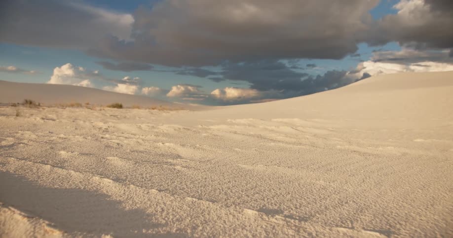 Sand stretches to the horizon under a cloudy sky