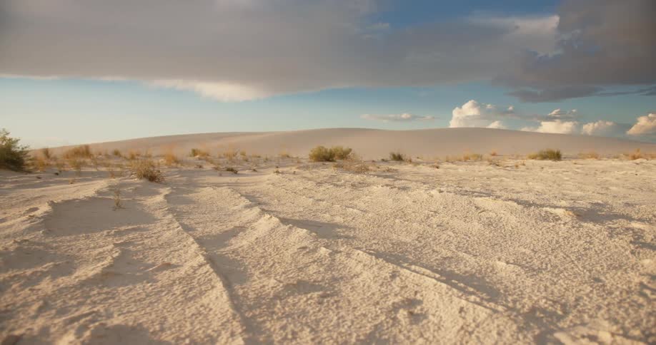 The camera moves across a arid desert landscape