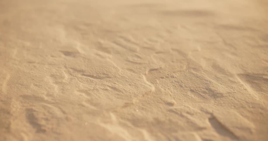 Close up shot of sand blowing away