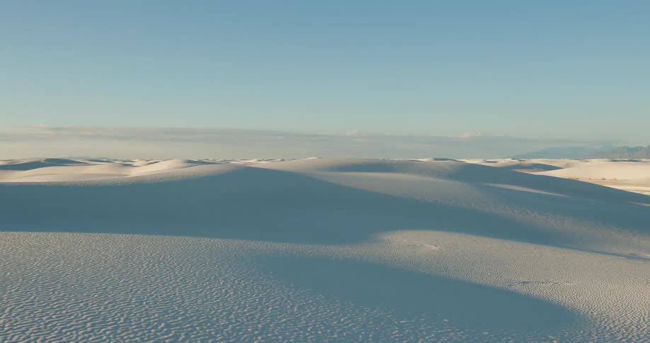 A vast desert of white dunes on a sunny day