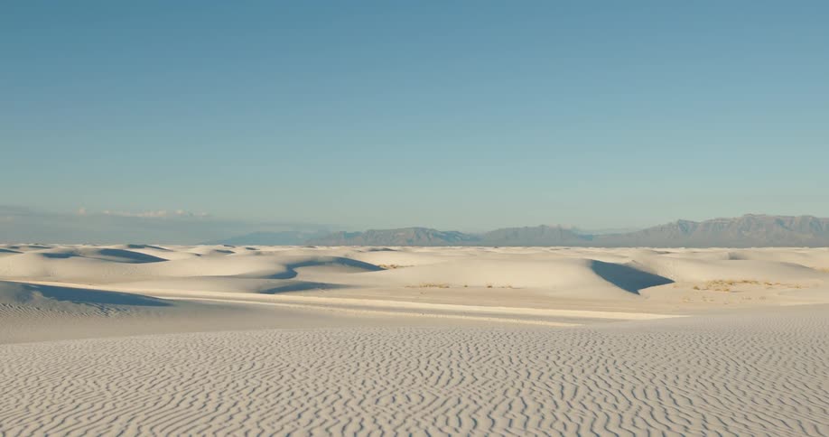 White sand dunes with mountains