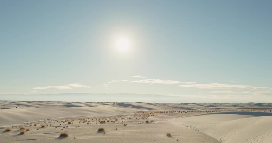The camera pans over a desert and sand dunes