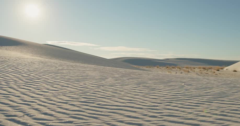 The bright sun shines on the sand in the desert