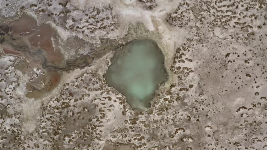 Birds eye view of a small lake on a desert