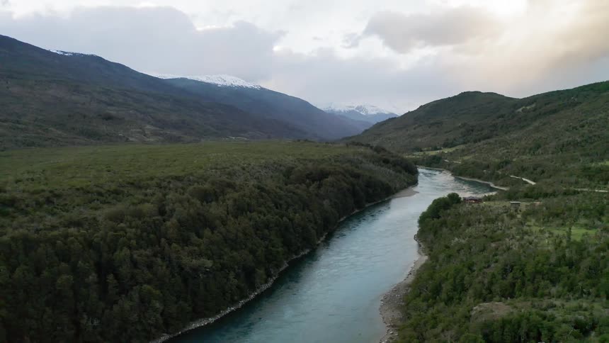 A river running through a forest and mountain area