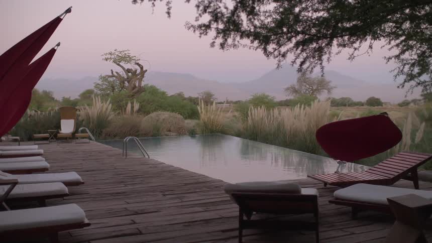 Slow camera pan that unveils a backyard pool