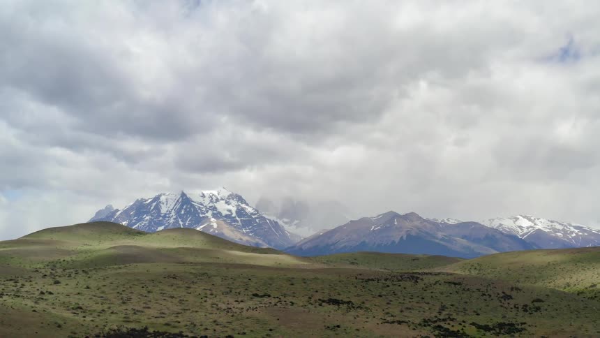 Rolling hillside with mountain landscape
