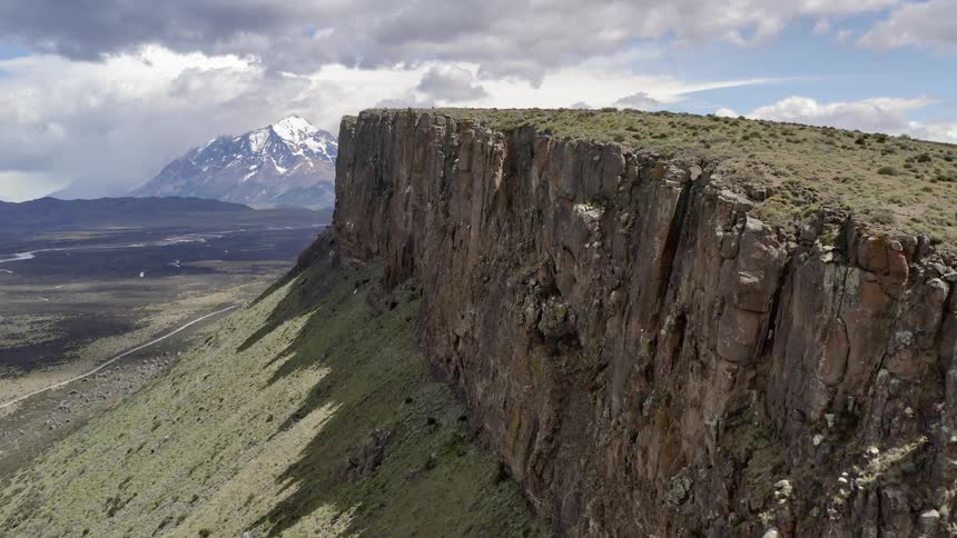 Viewing of cliffside with a large mountain in the distance