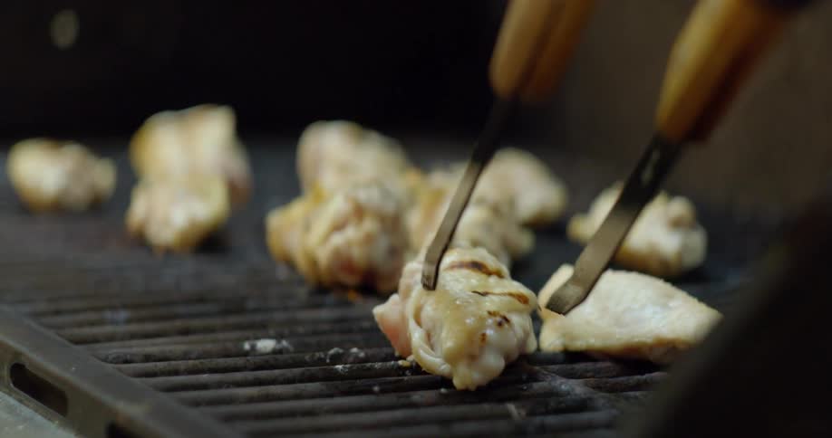 A person cooking chicken