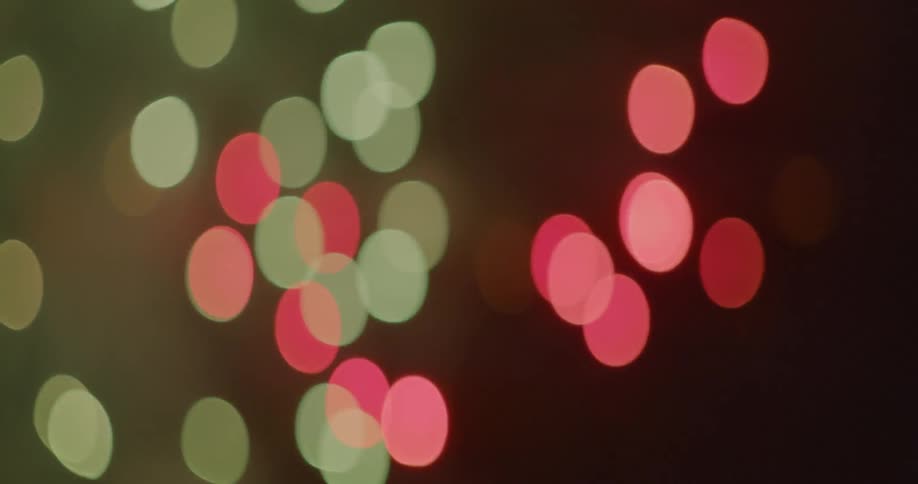 Pink and green dots bursting and floating through the air