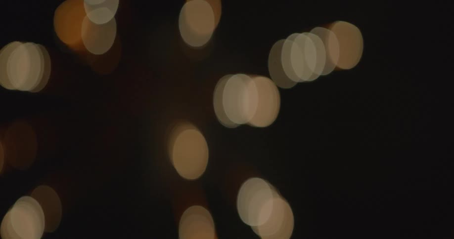 Out of focus red white gold fireworks exploding in the sky