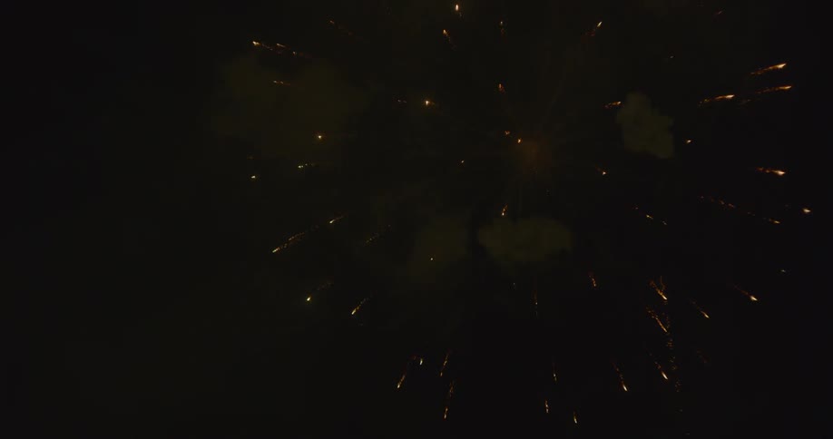 A burst of white and red fireworks in the sky