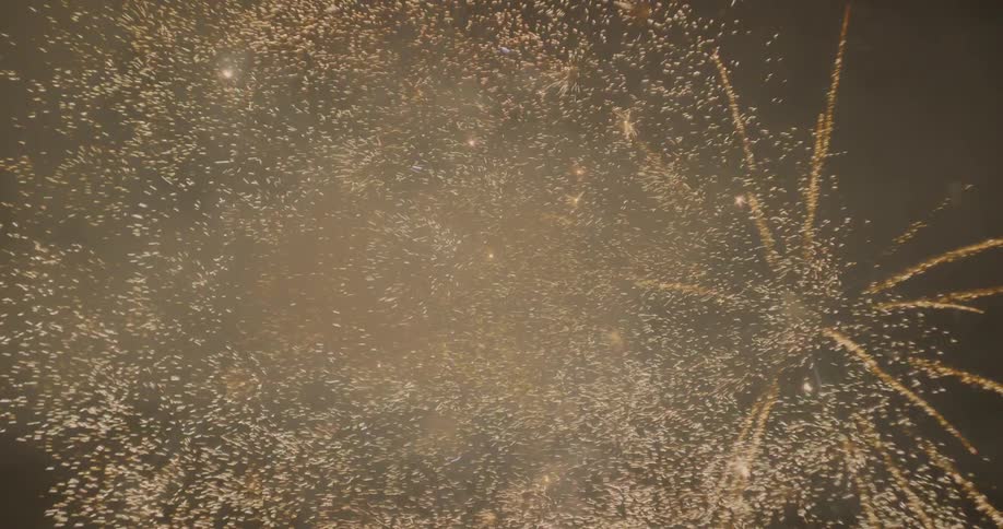 Bright fireworks and smoke in the night sky
