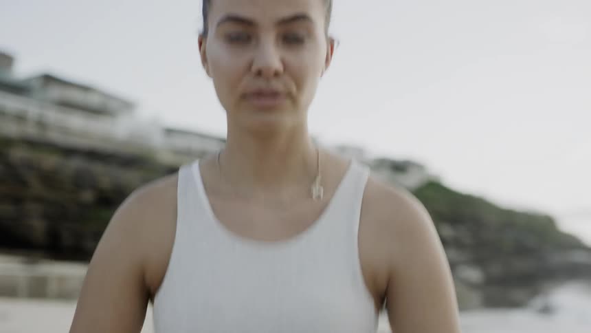 A woman is doing stretches outdoors