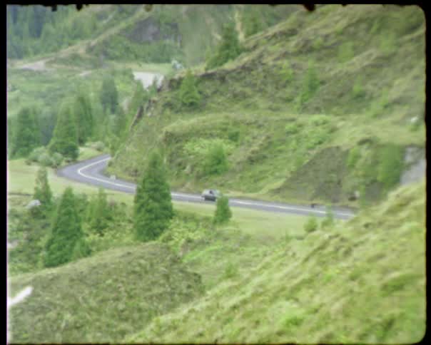 A car drives down the countryside road