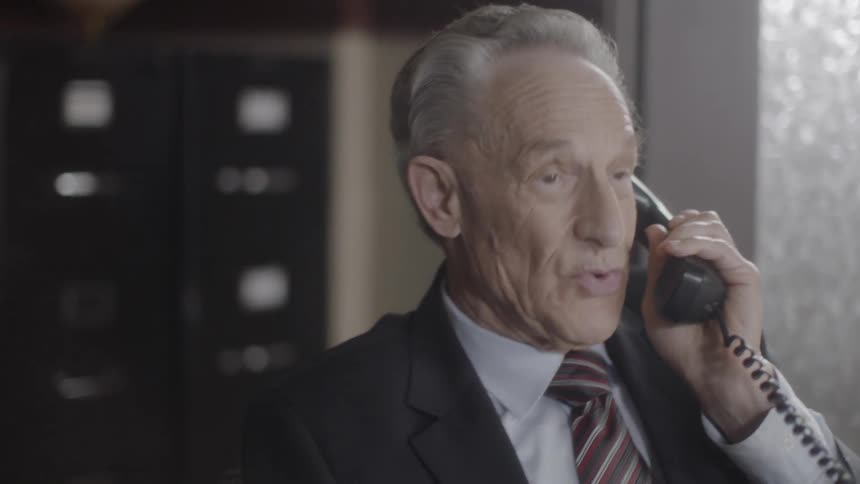A man picks up the phone and starts talking