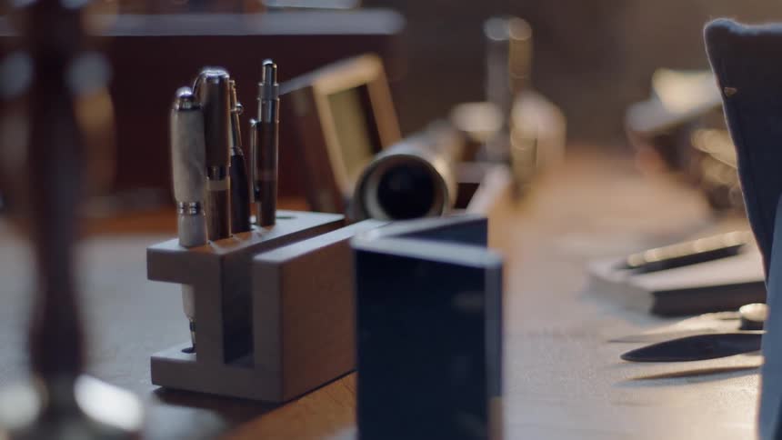 A desk with pens and other accessories