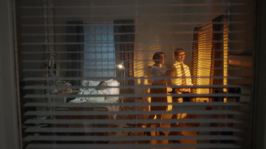 A hospital patient has two concerned people in the room