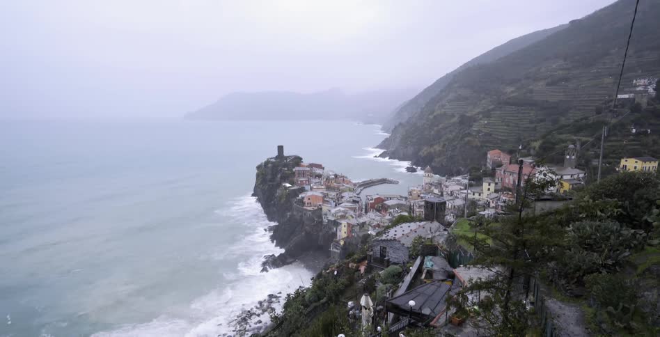 The waves are crashing along the shore of a city