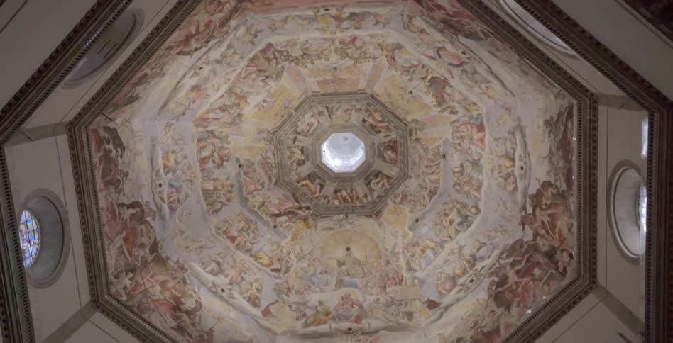 A painted dome ceiling with a window in the center