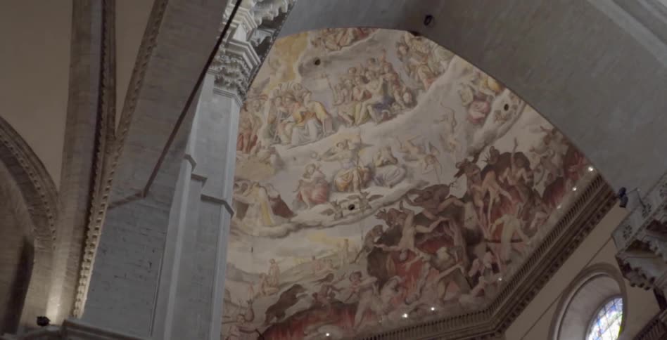 An ornately painted ceiling towers overhead