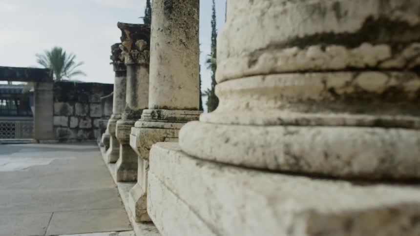 The camera pans out to a view of sculptured pillars