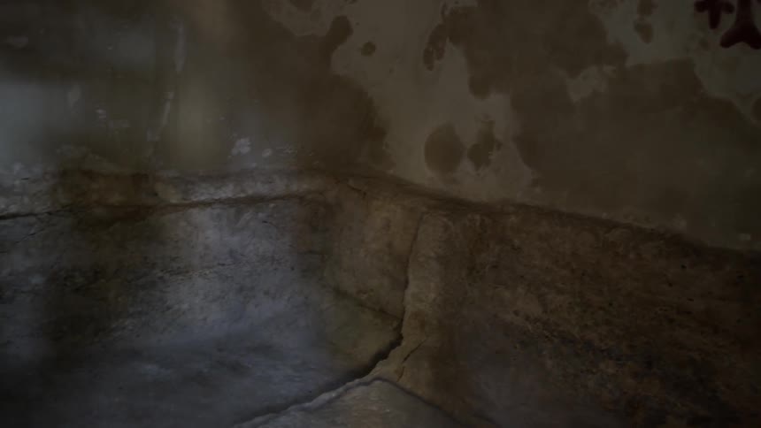 A marking on the wall of a dim old ruin
